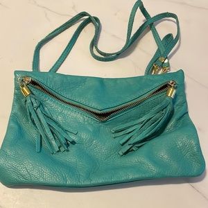 Small teal purse with wristlet attachment